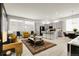 Open-concept living space featuring modern furniture, a kitchen island, and lots of natural light at 12258 Hazel Spruce Ct, Parker, CO 80134