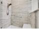 Walk-in shower with neutral tiles and a built in shower bench at 12258 Hazel Spruce Ct, Parker, CO 80134