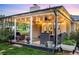 Inviting covered patio with string lights and comfortable seating, perfect for outdoor entertaining at 6303 E Dakota Ave, Denver, CO 80224