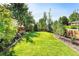 Lush backyard with healthy green lawn and beautiful landscaping for outdoor enjoyment at 6303 E Dakota Ave, Denver, CO 80224