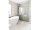 Modern bath displays a standalone tub beside a glass shower with decorative tiles and a rainfall shower head at 6303 E Dakota Ave, Denver, CO 80224