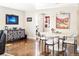 Bright dining room with hardwood floors, modern lighting fixture, and stylish decor, perfect for entertaining guests at 6303 E Dakota Ave, Denver, CO 80224