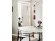 Charming Entryway With White Door and decorative glass; natural light filters in, highlighting the details at 6303 E Dakota Ave, Denver, CO 80224