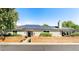Charming brick home with a manicured front yard and solar panels on the roof, perfect for energy efficiency at 6303 E Dakota Ave, Denver, CO 80224