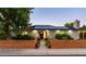 Charming brick home with a manicured front yard and solar panels on the roof, perfect for energy efficiency at 6303 E Dakota Ave, Denver, CO 80224