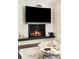 Modern fireplace with stone surround and a sleek design, creating a warm and inviting focal point at 6303 E Dakota Ave, Denver, CO 80224