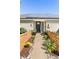 Inviting front entrance with a well-maintained walkway, planters, and solar panels on roof for energy at 6303 E Dakota Ave, Denver, CO 80224