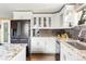 Modern kitchen with stainless steel appliances, granite countertops, and a pantry for ample storage at 6303 E Dakota Ave, Denver, CO 80224