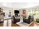 Cozy living room featuring a fireplace, hardwood floors, and comfortable seating, ideal for relaxation at 6303 E Dakota Ave, Denver, CO 80224
