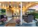 Covered back porch features string lights, seating, and outdoor fans at 6303 E Dakota Ave, Denver, CO 80224