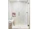 Shower features white marble-style tile, glass doors, and a built-in bench at 6303 E Dakota Ave, Denver, CO 80224