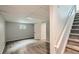 Finished basement space with grey vinyl flooring and staircase at 8897 Wagner Ln, Westminster, CO 80031