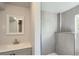 Bathroom with gray tiled shower, modern vanity, and bright lighting at 8897 Wagner Ln, Westminster, CO 80031