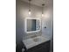 Well-lit bathroom with a modern vanity, sleek mirror, and stylish pendant lights at 8897 Wagner Ln, Westminster, CO 80031