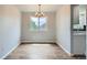Inviting dining room with hardwood floors, a stylish chandelier, and plenty of natural light from the window at 8897 Wagner Ln, Westminster, CO 80031