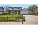 Inviting two-story home with stone accents, a well-maintained lawn, and a convenient two-car garage at 8897 Wagner Ln, Westminster, CO 80031