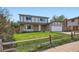 Charming two-story home featuring stone accents, a well-manicured lawn, and a welcoming two-car garage at 8897 Wagner Ln, Westminster, CO 80031