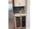 Bright beverage center featuring a wine cooler, white cabinets, and subway tile backsplash at 8897 Wagner Ln, Westminster, CO 80031