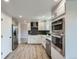Contemporary kitchen boasts stainless steel appliances, sleek cabinetry, and ample counter space for cooking at 8897 Wagner Ln, Westminster, CO 80031