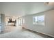 Spacious living room with large windows offering natural light and views, with an open layout to the kitchen at 8897 Wagner Ln, Westminster, CO 80031
