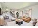 Bright living room with hardwood floors, a leather sofa, neutral colors, and an abundance of natural light at 8897 Wagner Ln, Westminster, CO 80031