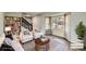Bright living room with hardwood floors, modern furniture, and large window with natural light at 8897 Wagner Ln, Westminster, CO 80031