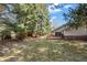 Expansive backyard featuring a lush lawn, mature trees, and a charming wooden deck, ideal for outdoor relaxation at 4862 Silver Sage Ct, Boulder, CO 80301