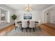 Well-lit dining room with an elegant chandelier, a large window, and neutral decor, creating a welcoming atmosphere at 4862 Silver Sage Ct, Boulder, CO 80301