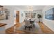 Elegant dining room featuring hardwood floors, a modern chandelier, and a large window, creating a bright ambiance at 4862 Silver Sage Ct, Boulder, CO 80301
