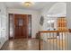 Inviting foyer with wood-trimmed door, ceramic tile floor, and a glimpse of the living room through an archway at 4862 Silver Sage Ct, Boulder, CO 80301