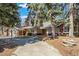Charming single-story brick and siding home with a tile roof, landscaped yard, and a long concrete driveway at 4862 Silver Sage Ct, Boulder, CO 80301