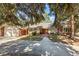 Charming single-story brick and siding home with a tile roof, landscaped yard, and a long concrete driveway at 4862 Silver Sage Ct, Boulder, CO 80301