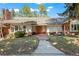 Charming single-story brick and siding home with a tile roof, landscaped yard, and a long concrete walkway at 4862 Silver Sage Ct, Boulder, CO 80301