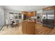 Bright kitchen island with stone countertops, stainless appliances, and eat in nook at 4862 Silver Sage Ct, Boulder, CO 80301