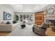 Bright living room featuring hardwood floors, a fireplace, large windows, and neutral-toned furniture at 4862 Silver Sage Ct, Boulder, CO 80301