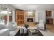 Bright living room featuring hardwood floors, a fireplace, large windows, and neutral-toned furniture at 4862 Silver Sage Ct, Boulder, CO 80301