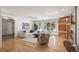 Bright living room featuring hardwood floors, a fireplace, large windows, and neutral-toned furniture at 4862 Silver Sage Ct, Boulder, CO 80301