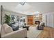Bright living room with hardwood floors, skylights, fireplace, and large windows overlooking the yard at 4862 Silver Sage Ct, Boulder, CO 80301
