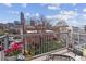 Balcony with city views, outdoor seating, a table, flowers, and a wrought iron railing at 1747 N Washington St # C306, Denver, CO 80203