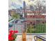 Balcony with city views, outdoor seating, a table, flowers, and a wrought iron railing at 1747 N Washington St # C306, Denver, CO 80203
