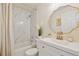 Stylish bathroom with a modern vanity, ornate mirror, and shower over tub with marble-style tiling at 1747 N Washington St # C306, Denver, CO 80203