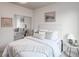 Bright bedroom with soft decor, mirrored closet, and a comfy upholstered bed and side tables at 1747 N Washington St # C306, Denver, CO 80203