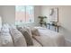 Bright bedroom with a large window, plants, and neutral color palette with a view of the city at 1747 N Washington St # C306, Denver, CO 80203