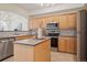 Well-equipped kitchen featuring stainless steel appliances, an island, and ample cabinet space at 1747 N Washington St # C306, Denver, CO 80203