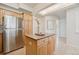 Bright kitchen features stainless steel refrigerator, wooden cabinets, and a granite-topped center island at 1747 N Washington St # C306, Denver, CO 80203