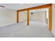 Finished basement with exposed wooden beams and neutral carpeting, ready to be personalized at 3766 E Easter S Cir, Centennial, CO 80122