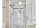 Modern tiled shower featuring glass doors and a decorative accent window at 3766 E Easter S Cir, Centennial, CO 80122