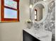 Chic bathroom with decorative wallpaper, modern vanity, and stylish mirror at 3766 E Easter S Cir, Centennial, CO 80122