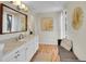 Bright bathroom featuring a long vanity with double sinks and a decoratively adorned seating area at 3766 E Easter S Cir, Centennial, CO 80122