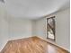 Bedroom featuring hardwood floors and a large window with outdoor views at 3766 E Easter S Cir, Centennial, CO 80122